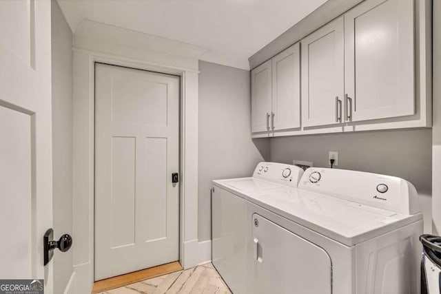 481 Meadow Lake Ter, Hoschton, GA 30548 - washroom featuring washing machine and dryer, cabinet space, and light wood finished floors