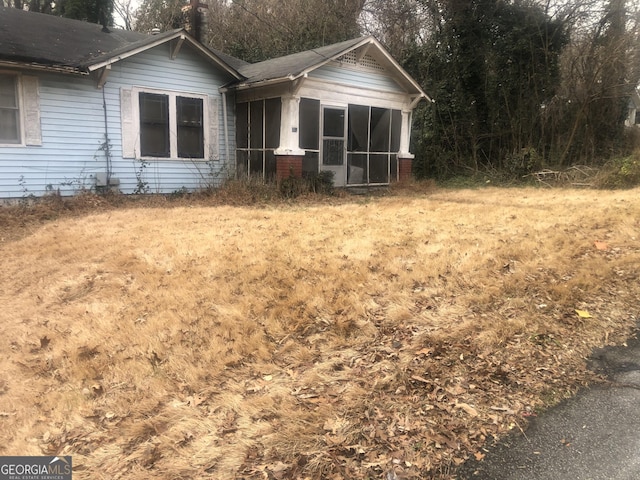 702 Emily Pl NW Unit 0, Atlanta, GA 30318 - view of front of home with a sunroom and a shingled roof