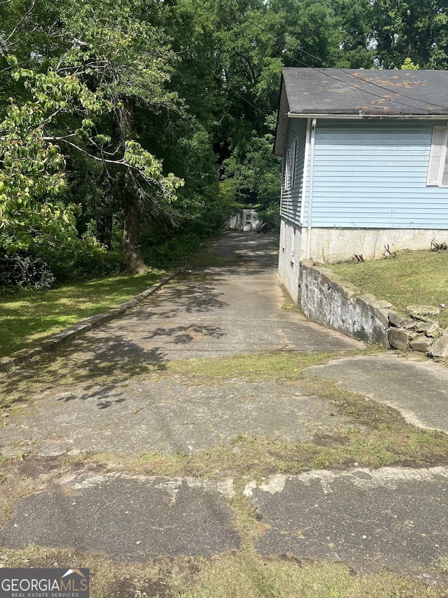 702 Emily Pl NW Unit 0, Atlanta, GA 30318 - view of property exterior with roof with shingles and asphalt driveway