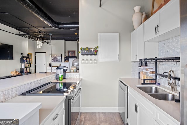 120 Ralph Mcgill Blvd NE Apt 1409, Atlanta, GA 30308 - kitchen with stainless steel appliances, wood finished floors, tasteful backsplash, light countertops, and white cabinets