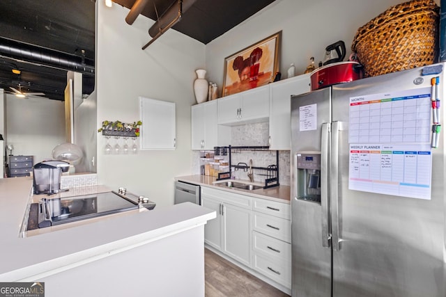 120 Ralph Mcgill Blvd NE Apt 1409, Atlanta, GA 30308 - kitchen featuring appliances with stainless steel finishes, decorative backsplash, white cabinets, light countertops, and light wood finished floors