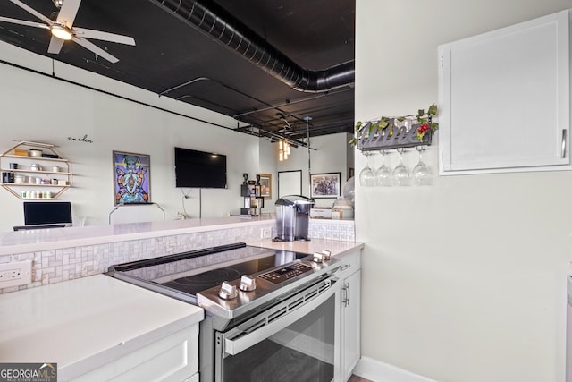 120 Ralph Mcgill Blvd NE Apt 1409, Atlanta, GA 30308 - kitchen featuring electric range, white cabinetry, light countertops, and open floor plan