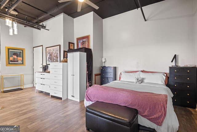 120 Ralph Mcgill Blvd NE Apt 1409, Atlanta, GA 30308 - bedroom featuring wood finished floors, a towering ceiling, and ceiling fan