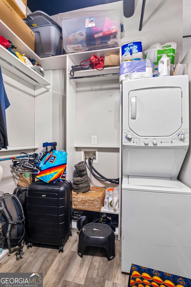 120 Ralph Mcgill Blvd NE Apt 1409, Atlanta, GA 30308 - washroom with stacked washing machine and dryer and wood finished floors