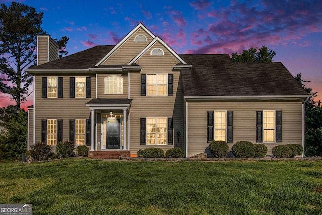 2275 Holly Run Dr, Jonesboro, GA 30236 - view of front of home with a chimney, a front yard, and a shingled roof