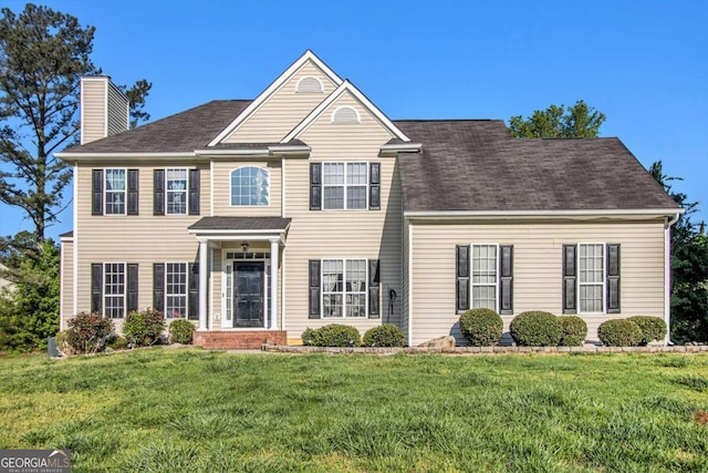 2275 Holly Run Dr, Jonesboro, GA 30236 - view of front facade with a chimney, a front lawn, and a shingled roof