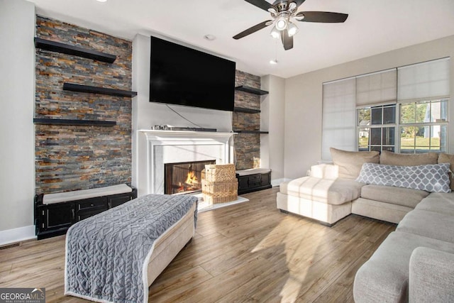 2275 Holly Run Dr, Jonesboro, GA 30236 - living area with a glass covered fireplace, a ceiling fan, and wood finished floors