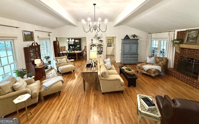1055 E Hermitage Rd NE, Rome, GA 30161 - living room with a chandelier, light wood finished floors, and a brick fireplace