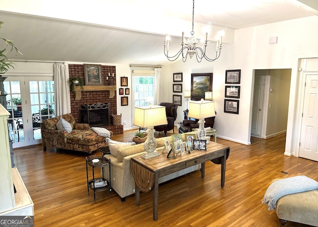 1055 E Hermitage Rd NE, Rome, GA 30161 - living area featuring a chandelier, wood finished floors, and a brick fireplace