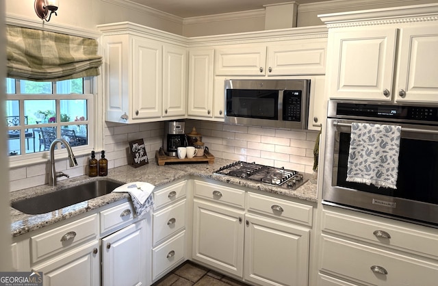1055 E Hermitage Rd NE, Rome, GA 30161 - kitchen with appliances with stainless steel finishes, tasteful backsplash, crown molding, and white cabinets