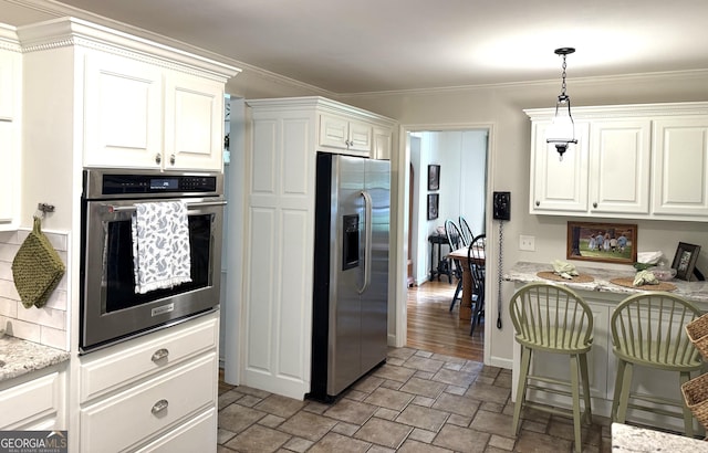 1055 E Hermitage Rd NE, Rome, GA 30161 - kitchen featuring appliances with stainless steel finishes, stone finish flooring, white cabinets, ornamental molding, and light stone countertops
