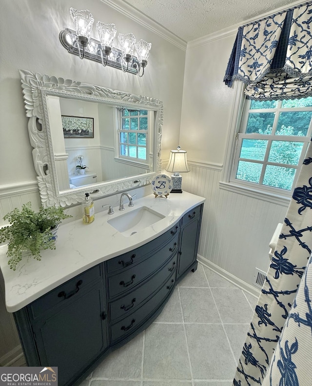 1055 E Hermitage Rd NE, Rome, GA 30161 - full bathroom with a wainscoted wall, a textured ceiling, vanity, tile patterned flooring, and ornamental molding