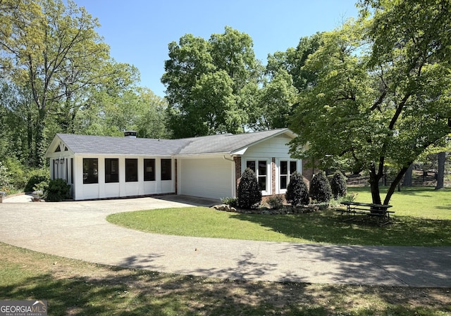 1055 E Hermitage Rd NE, Rome, GA 30161 - view of front of property featuring concrete driveway, a garage, a front lawn, and brick siding