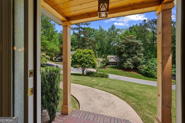 3912 Edenton Ct, Brookhaven, GA 30319 - covered porch featuring a yard and view of wooded area