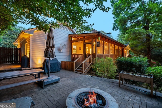 3912 Edenton Ct, Brookhaven, GA 30319 - rear view of property with an outdoor fire pit, a patio area, and a sunroom