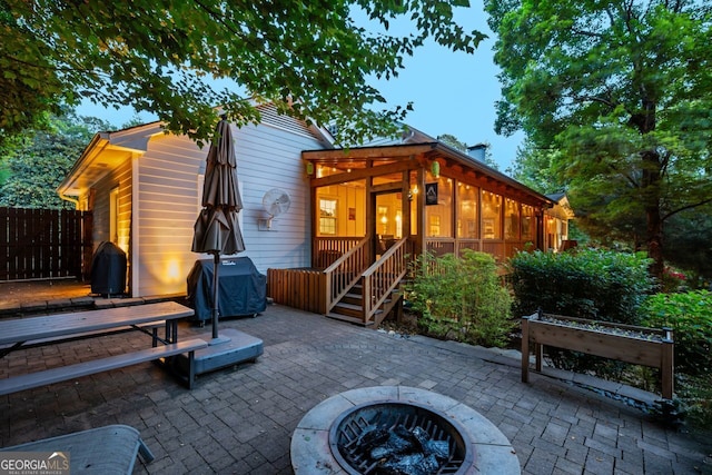 3912 Edenton Ct, Brookhaven, GA 30319 - back of property with a fire pit, a patio area, and a sunroom