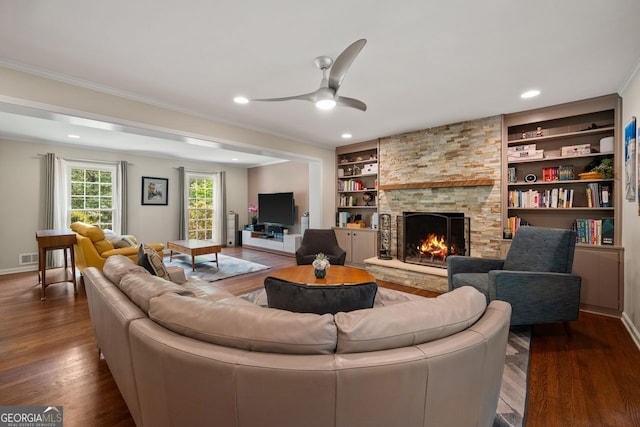 3912 Edenton Ct, Brookhaven, GA 30319 - living room featuring dark wood-type flooring, a fireplace, built in shelves, a ceiling fan, and crown molding