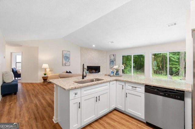 4818 Terrace Green Trce, Stone Mountain, GA 30088 - kitchen featuring dishwasher, open floor plan, light wood-style floors, white cabinets, and a fireplace