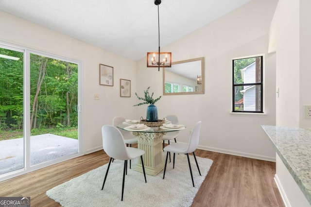 4818 Terrace Green Trce, Stone Mountain, GA 30088 - dining room with wood finished floors, lofted ceiling, and a chandelier