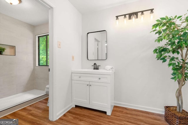 4818 Terrace Green Trce, Stone Mountain, GA 30088 - full bathroom with vanity, wood finished floors, and tiled shower