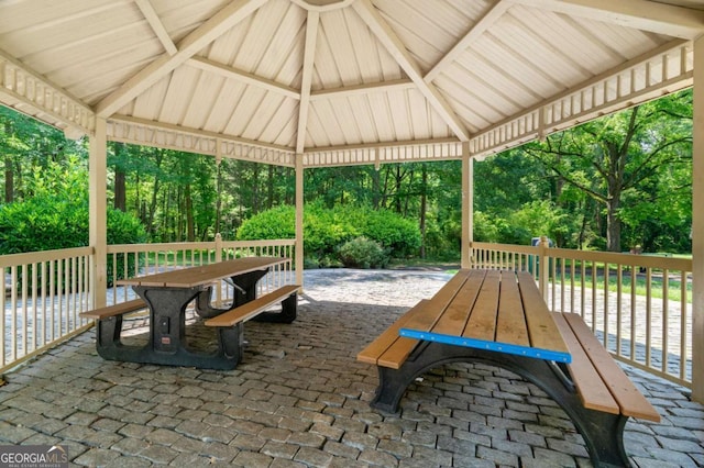 4818 Terrace Green Trce, Stone Mountain, GA 30088 - view of patio / terrace featuring outdoor dining area, a gazebo, and view of scattered trees