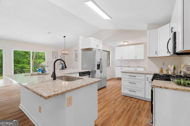 4818 Terrace Green Trce, Stone Mountain, GA 30088 - kitchen with stainless steel appliances, vaulted ceiling, light wood finished floors, light stone counters, and white cabinetry