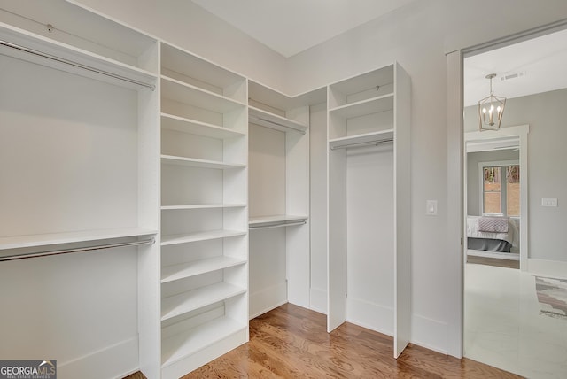 172 Forest Berry Ct Lot 100M2A, Newnan, GA 30265 - spacious closet featuring a chandelier and wood finished floors