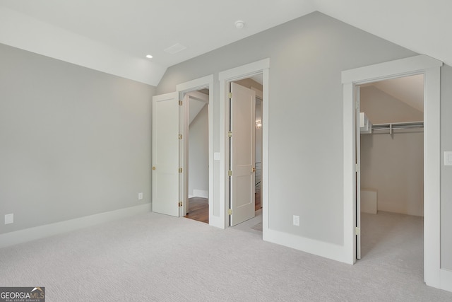 172 Forest Berry Ct Lot 100M2A, Newnan, GA 30265 - unfurnished bedroom with vaulted ceiling, carpet flooring, a spacious closet, and a closet