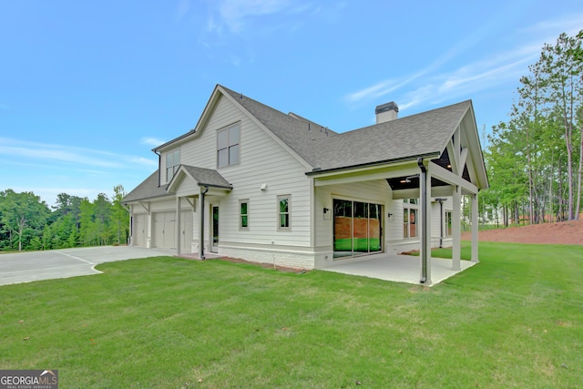 172 Forest Berry Ct Lot 100M2A, Newnan, GA 30265 - view of home's exterior with a chimney, a yard, roof with shingles, driveway, and a patio area