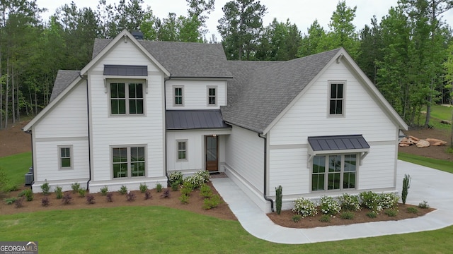172 Forest Berry Ct Lot 100M2A, Newnan, GA 30265 - modern farmhouse style home with a standing seam roof, roof with shingles, a front yard, and a metal roof