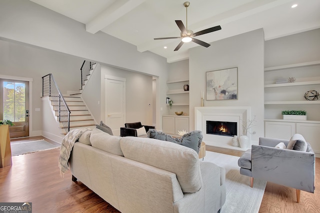 172 Forest Berry Ct Lot 100M2A, Newnan, GA 30265 - living area with stairs, built in shelves, ceiling fan, light wood finished floors, and a lit fireplace