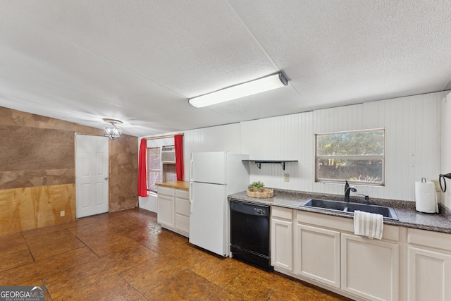 99 Conifer Dr, Guyton, GA 31312 - kitchen featuring black dishwasher, freestanding refrigerator, a textured ceiling, a wall unit AC, and dark countertops