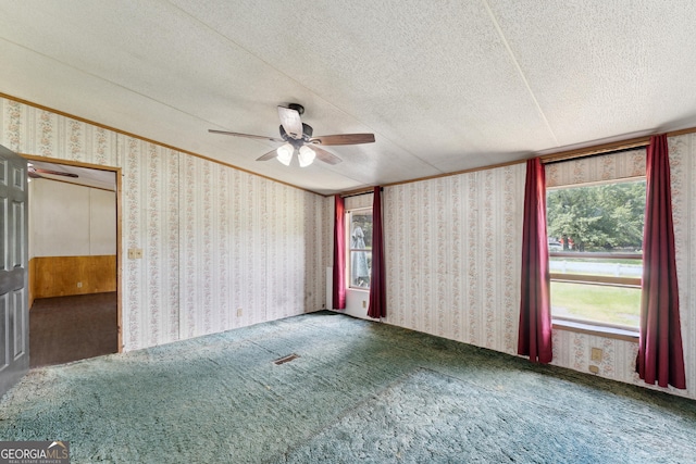 99 Conifer Dr, Guyton, GA 31312 - carpeted empty room with ceiling fan, wallpapered walls, and a textured ceiling