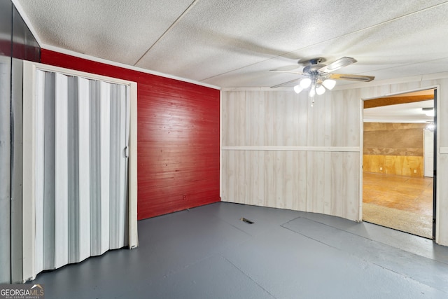 99 Conifer Dr, Guyton, GA 31312 - unfurnished room with wooden walls, ceiling fan, and a textured ceiling