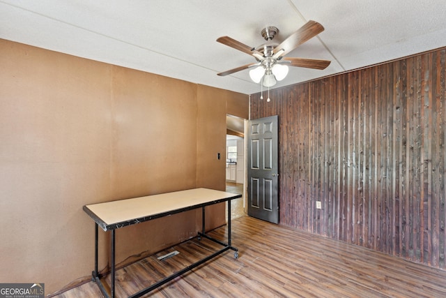 99 Conifer Dr, Guyton, GA 31312 - office area featuring wood finished floors, a ceiling fan, and wood walls