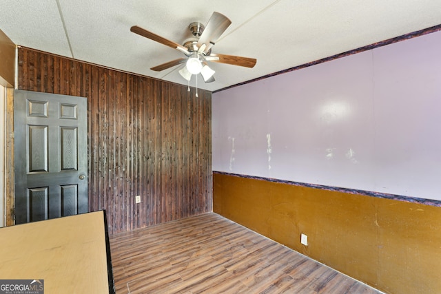 99 Conifer Dr, Guyton, GA 31312 - spare room with a ceiling fan, wooden walls, wood finished floors, and ornamental molding