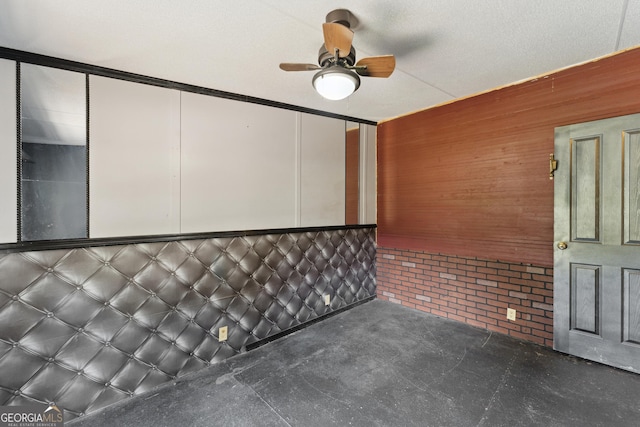 99 Conifer Dr, Guyton, GA 31312 - spare room featuring a ceiling fan and wooden walls