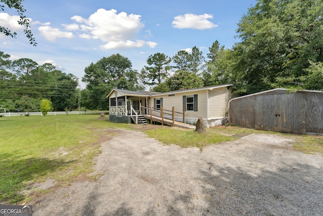 99 Conifer Dr, Guyton, GA 31312 - manufactured / mobile home with a sunroom and a front yard