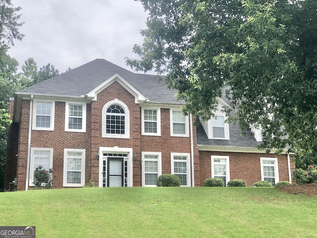 1433 Cotton Trl SW, Conyers, GA 30094 - colonial-style house featuring a front lawn, brick siding, and roof with shingles