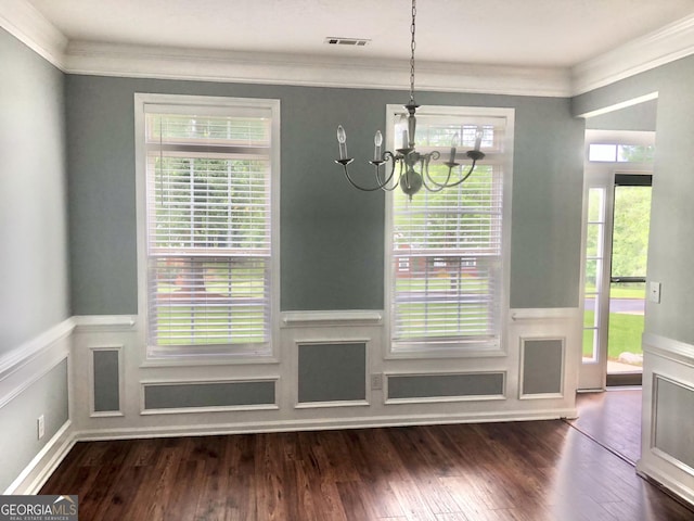 1433 Cotton Trl SW, Conyers, GA 30094 - unfurnished dining area with a chandelier, ornamental molding, wainscoting, and dark wood-style floors