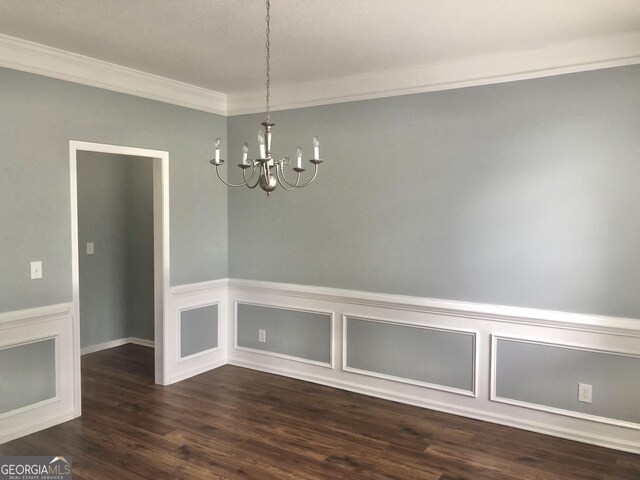1433 Cotton Trl SW, Conyers, GA 30094 - unfurnished dining area with crown molding, a chandelier, dark wood-style floors, and a wainscoted wall