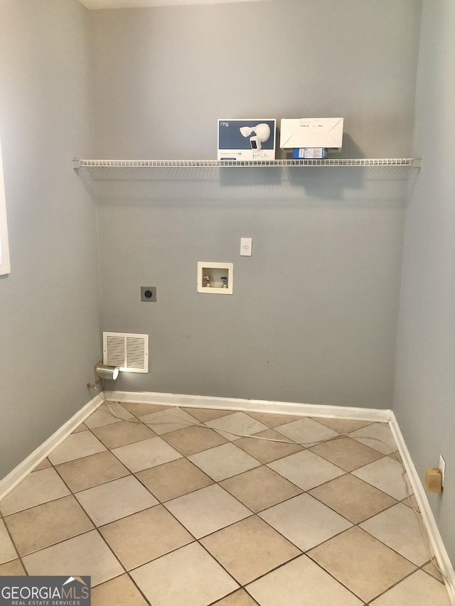 1433 Cotton Trl SW, Conyers, GA 30094 - laundry area with washer hookup, electric dryer hookup, and light tile patterned flooring