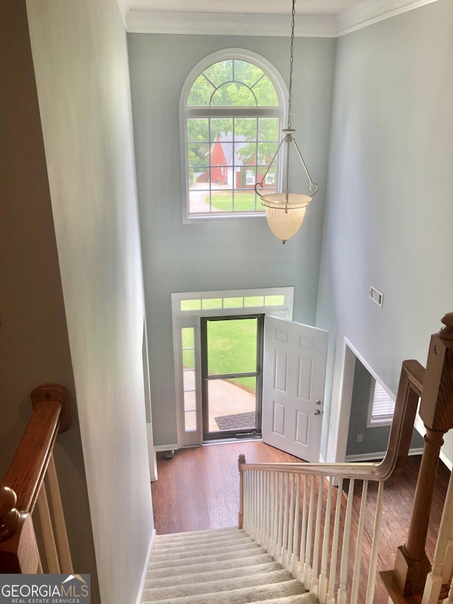 1433 Cotton Trl SW, Conyers, GA 30094 - entrance foyer with wood finished floors, crown molding, a towering ceiling, and stairs