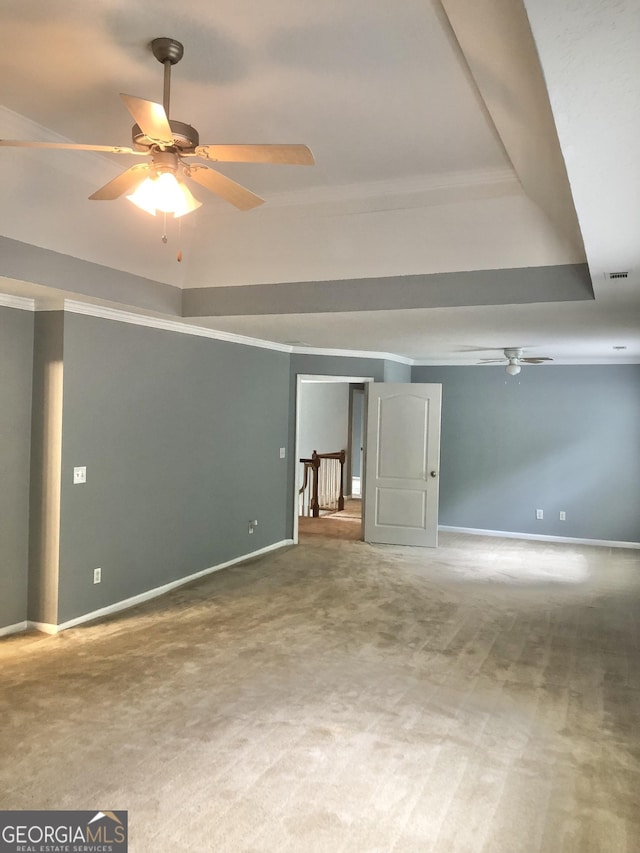 1433 Cotton Trl SW, Conyers, GA 30094 - empty room with ceiling fan, carpet, ornamental molding, and a raised ceiling