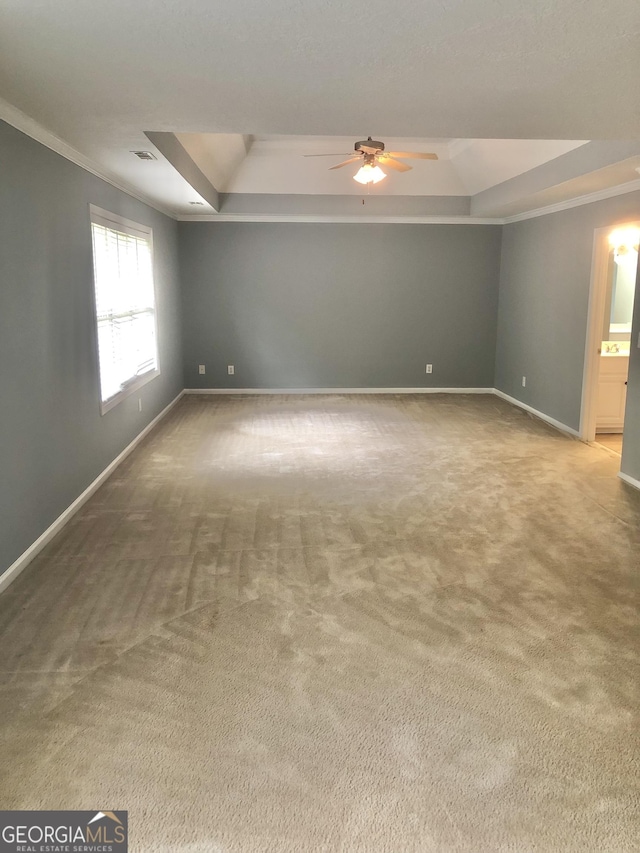 1433 Cotton Trl SW, Conyers, GA 30094 - unfurnished room with a tray ceiling, crown molding, carpet floors, and a ceiling fan