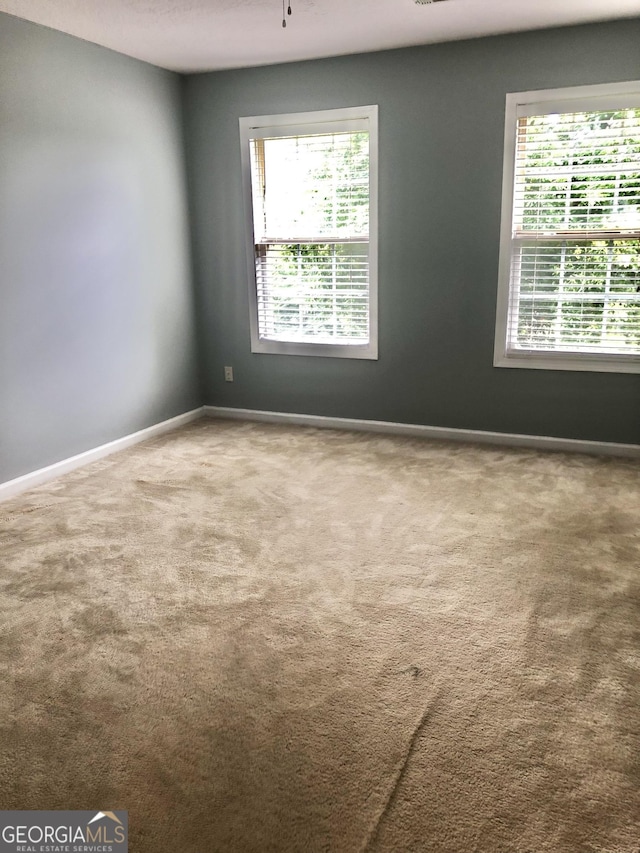 1433 Cotton Trl SW, Conyers, GA 30094 - carpeted empty room featuring plenty of natural light