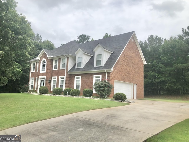 1433 Cotton Trl SW, Conyers, GA 30094 - colonial-style house with brick siding, concrete driveway, a front lawn, and roof with shingles