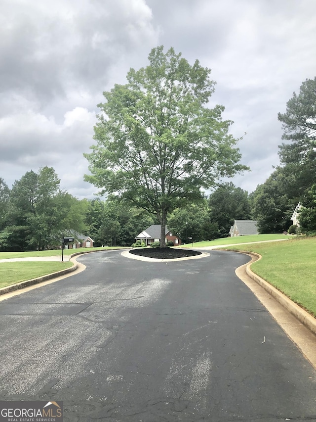 1433 Cotton Trl SW, Conyers, GA 30094 - view of asphalt road featuring curbs and view of wooded area
