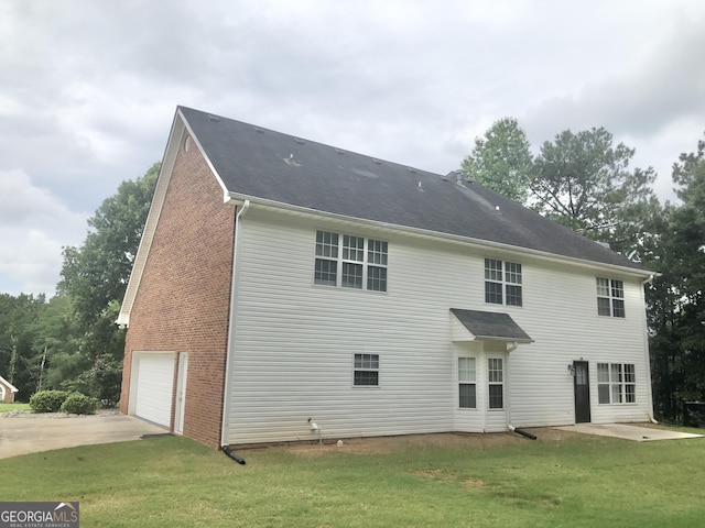 1433 Cotton Trl SW, Conyers, GA 30094 - rear view of house with concrete driveway, a lawn, and a garage