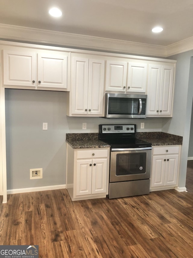 1433 Cotton Trl SW, Conyers, GA 30094 - kitchen featuring stainless steel appliances, crown molding, white cabinetry, dark wood-type flooring, and recessed lighting